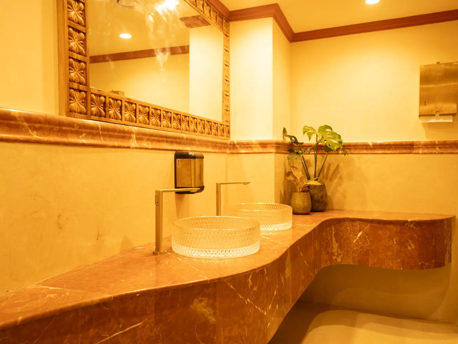 Curved red-marble vanity with crystal basins — Chalukya Samrat